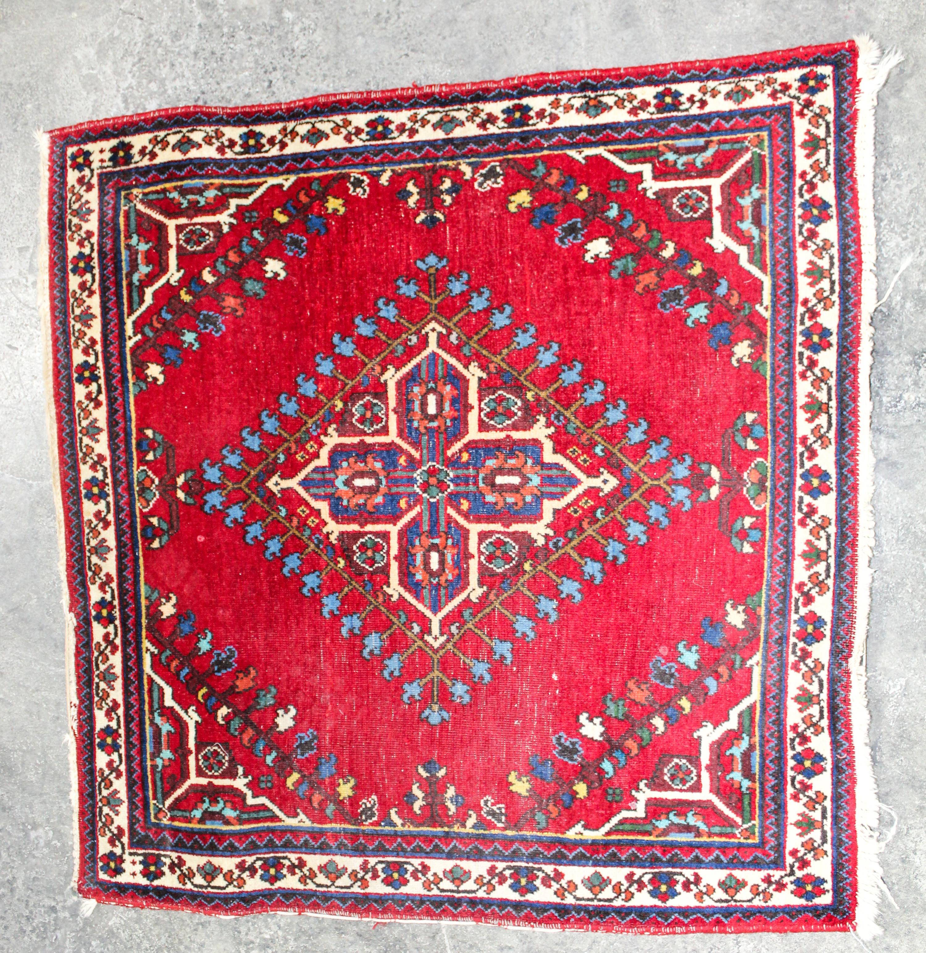 A Persian Mat 2 feet 9 inches x 2 feet 8 inches.