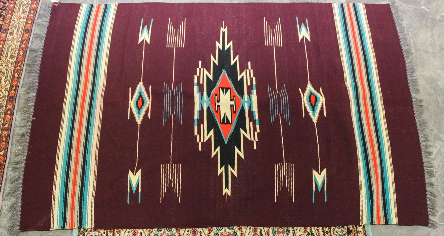 A Native American Rug 5 feet 8 inches x 3 feet 9 inches.