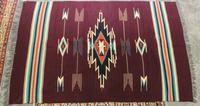 A Native American Rug 5 feet 8 inches x 3 feet 9 inches.