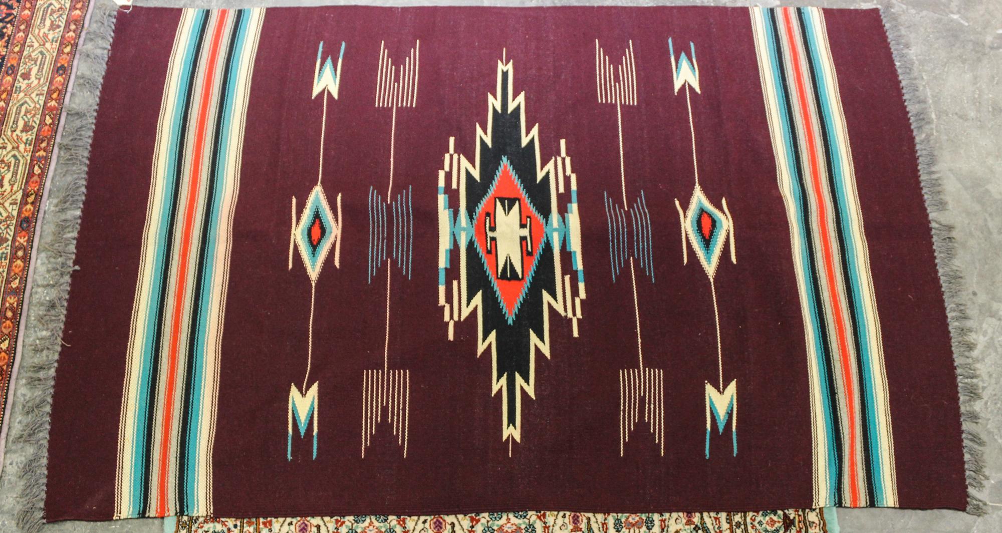 A Native American Rug 5 feet 8 inches x 3 feet 9 inches.
