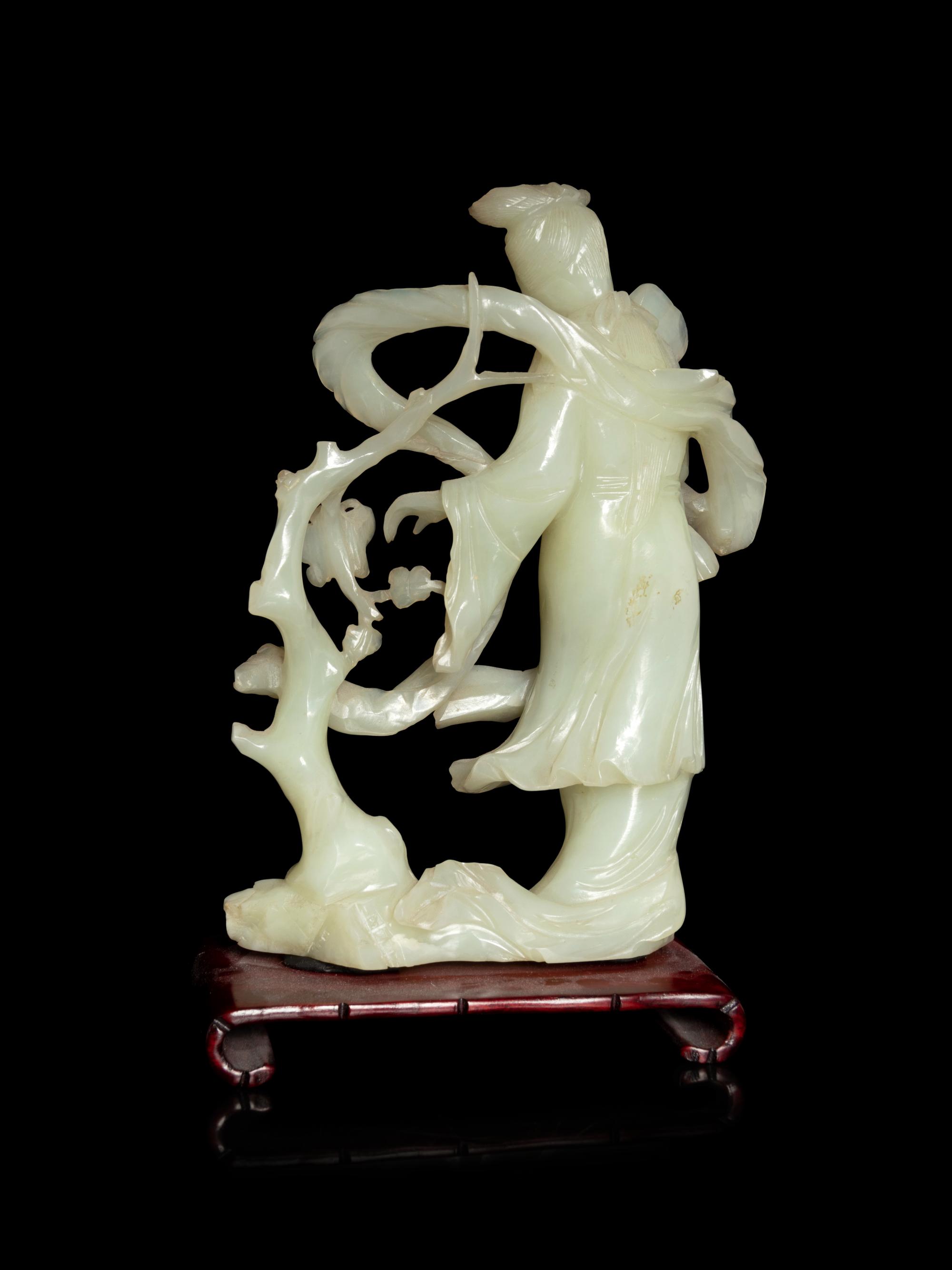 A Chinese Celadon Jade Figure of a Female Immortal