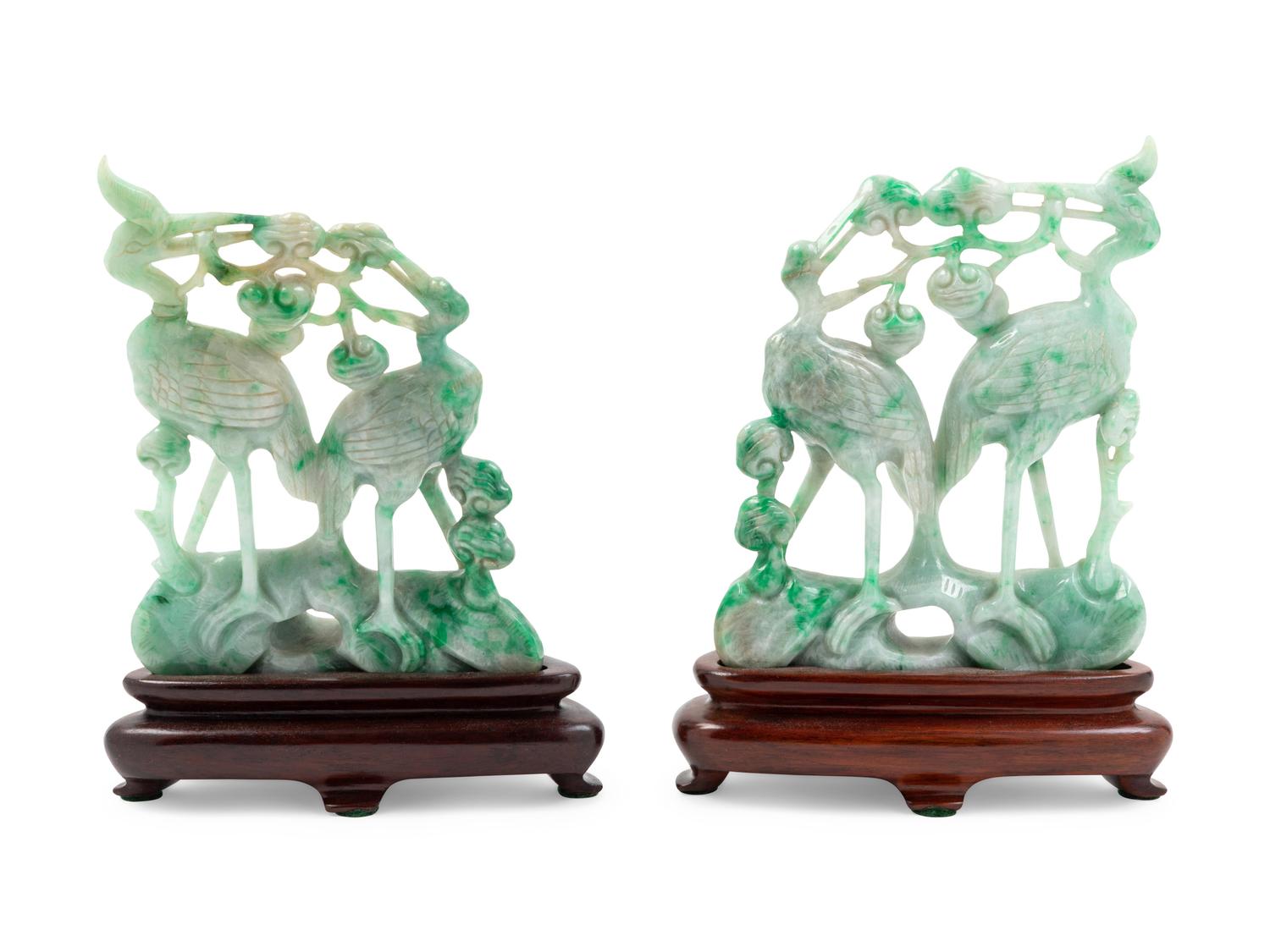 A Pair of Chinese Green and Celadon Jadeite Figural Groups of Cranes