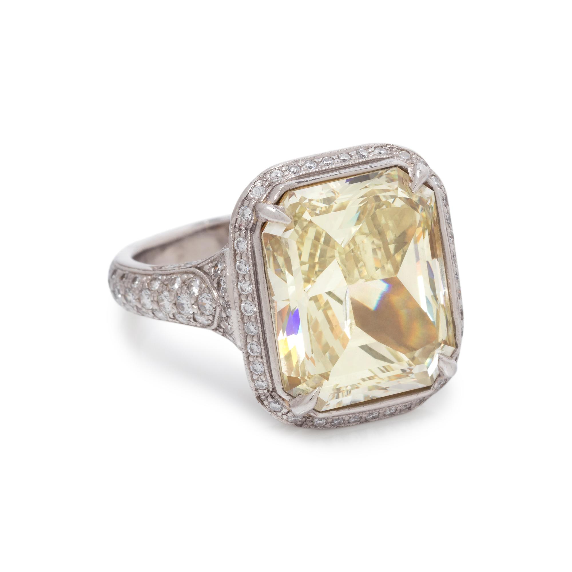 AN IMPRESSIVE FANCY YELLOW DIAMOND AND DIAMOND RING