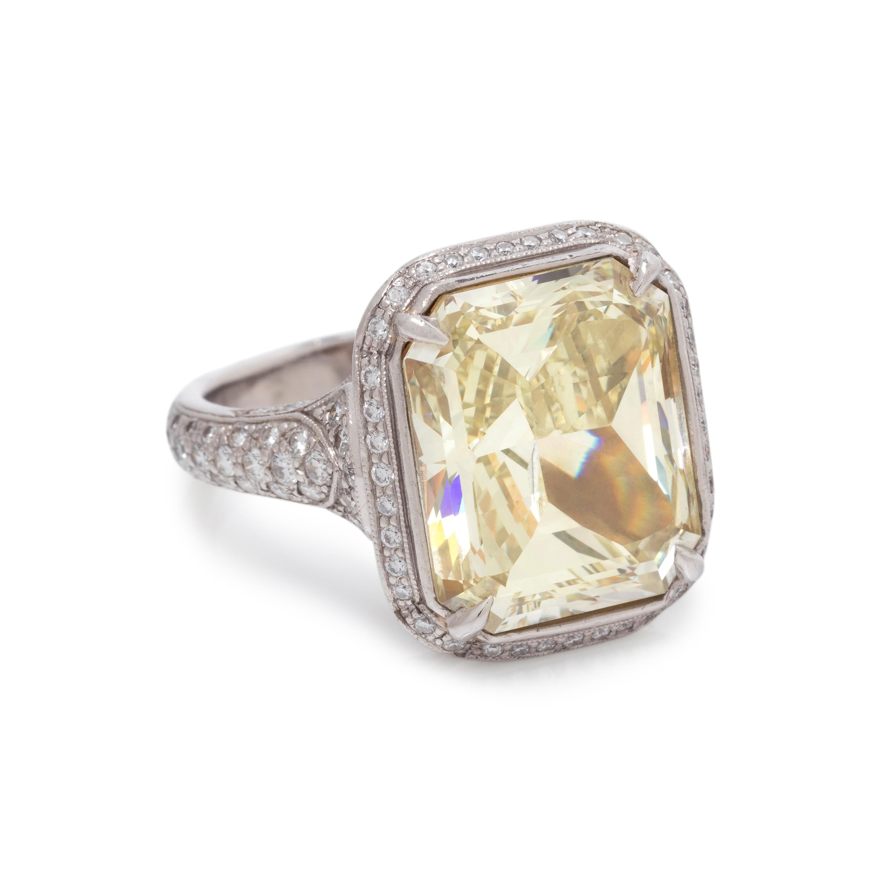 AN IMPRESSIVE FANCY YELLOW DIAMOND AND DIAMOND RING