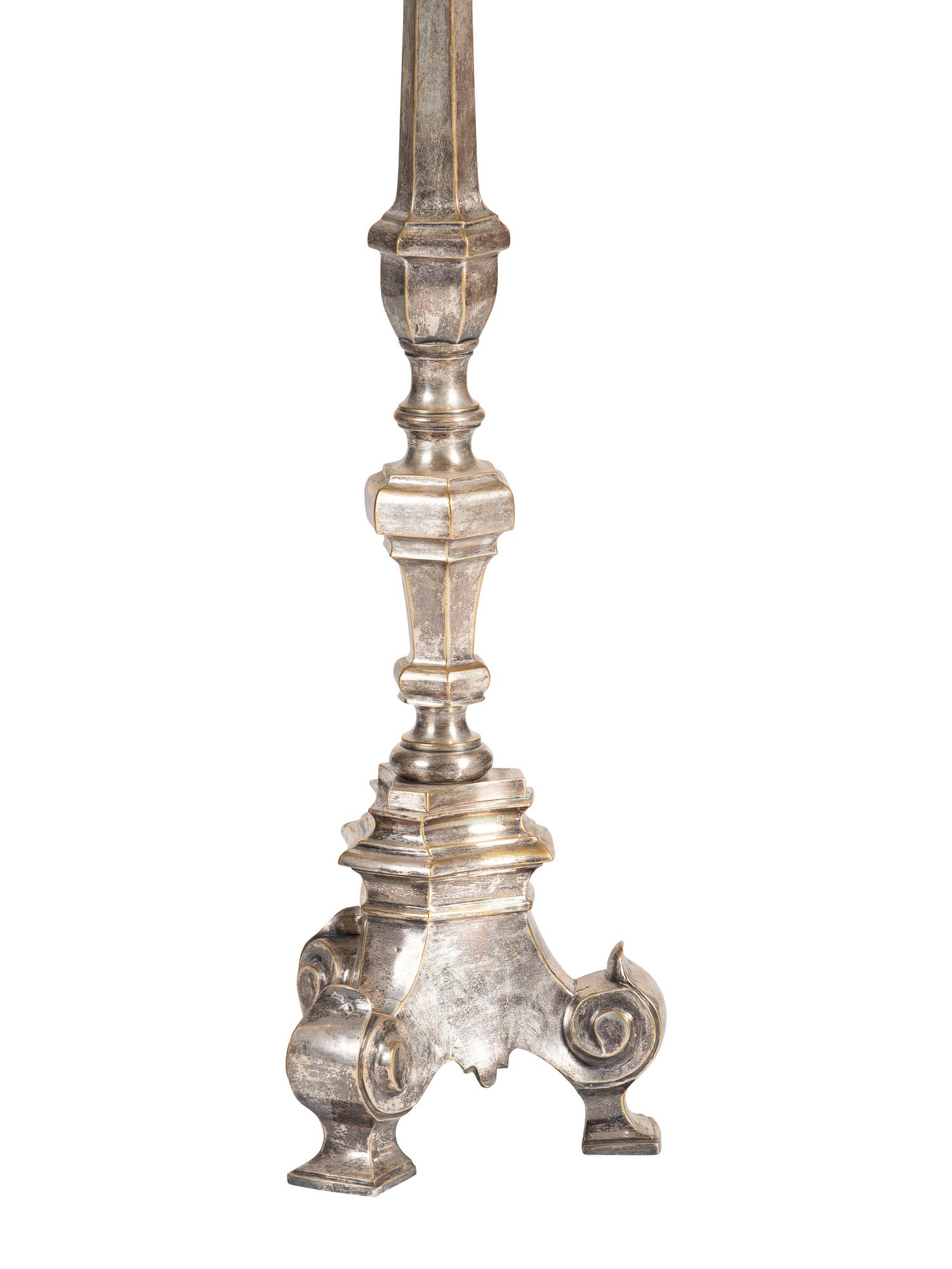 A Pair of Continental Baroque Style Silvered Brass Floor Candlestands