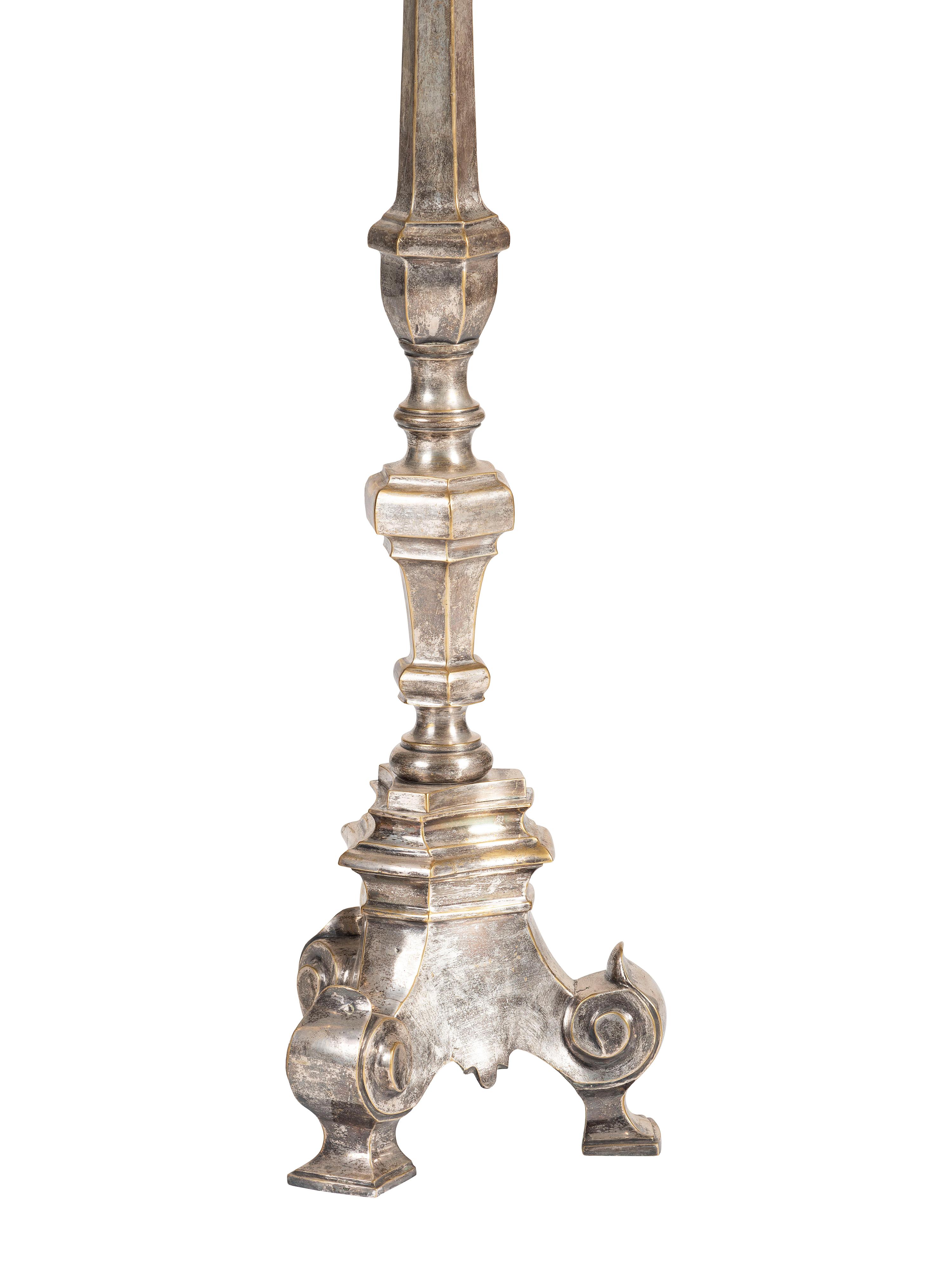 A Pair of Continental Baroque Style Silvered Brass Floor Candlestands