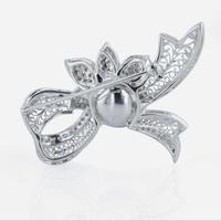 An 18K white gold, Tahitian cultured pearl, and diamond brooch