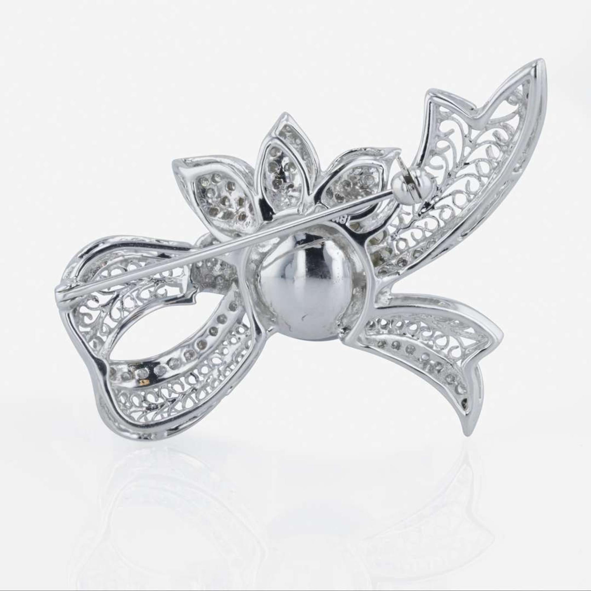 An 18K white gold, Tahitian cultured pearl, and diamond brooch