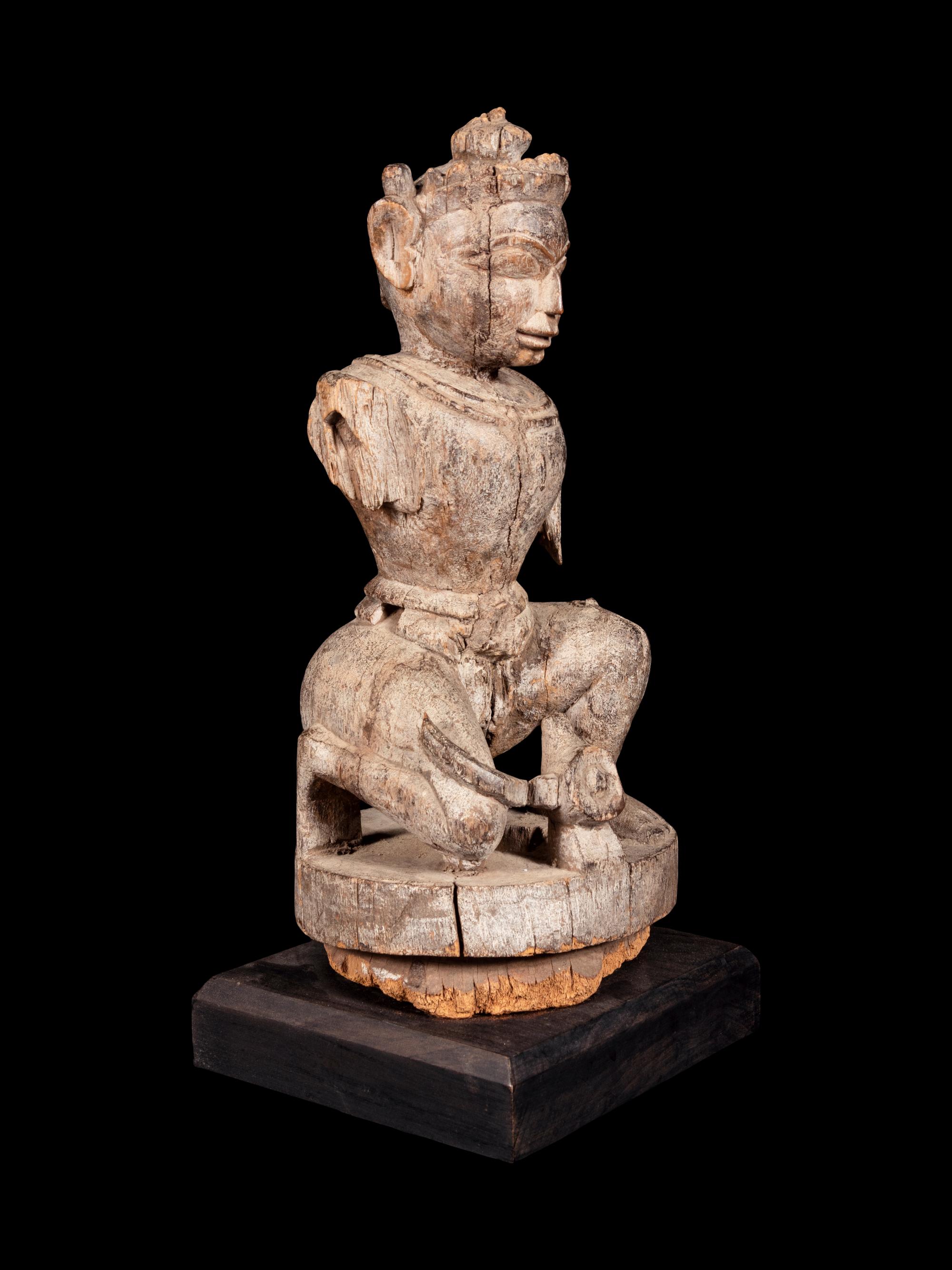 An Indian Carved Wood Figure of a Deity