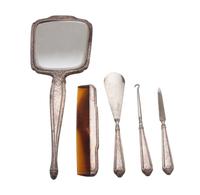 An American Silver Dresser Set, INTERNATIONAL SILVER CO., comprising a hand mirror, comb, button hook, shoe horn and nail file