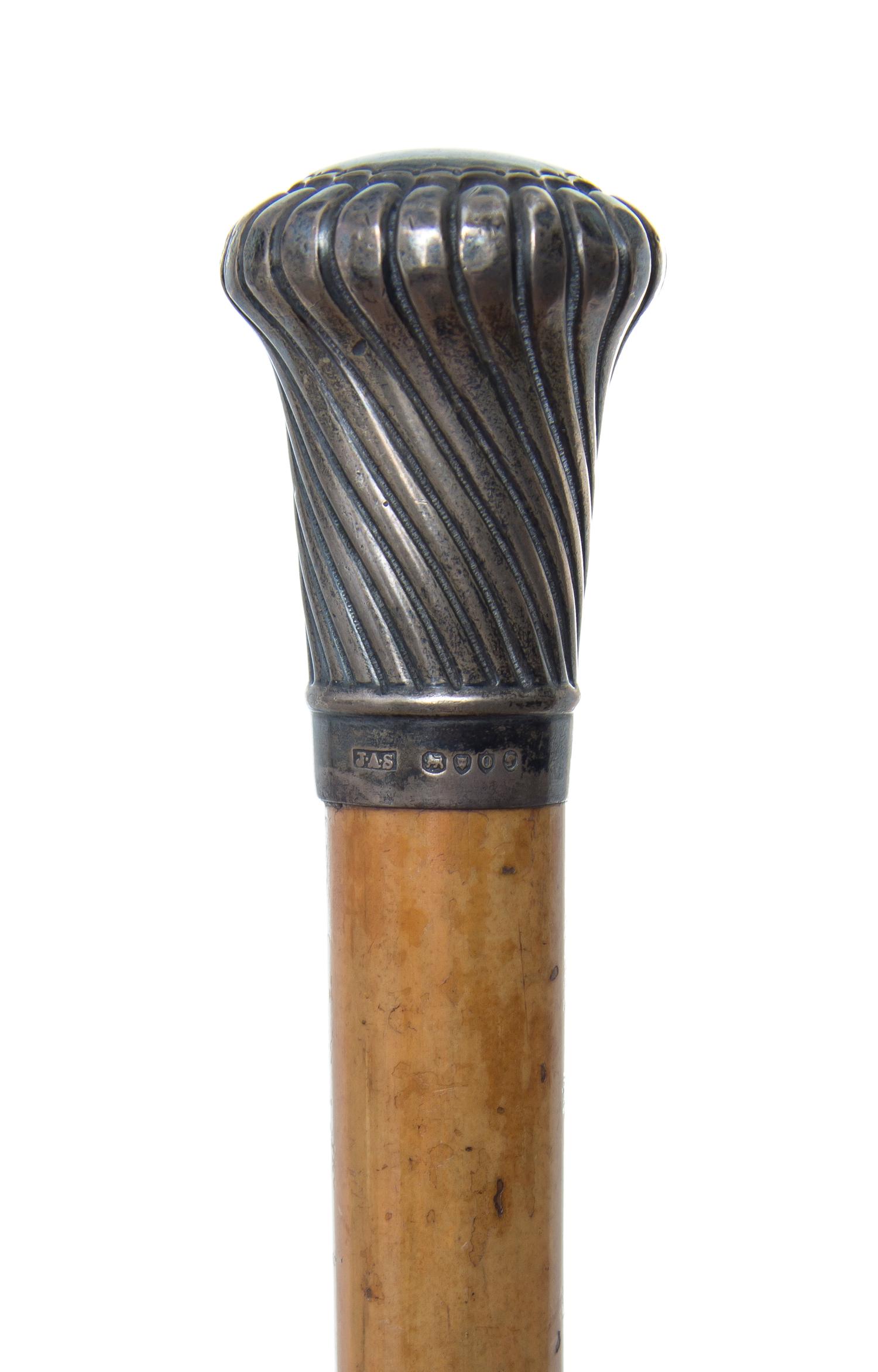 An English Silver Handled Walking Stick, Length of handle 2 1/8 x length overall 35 inches.