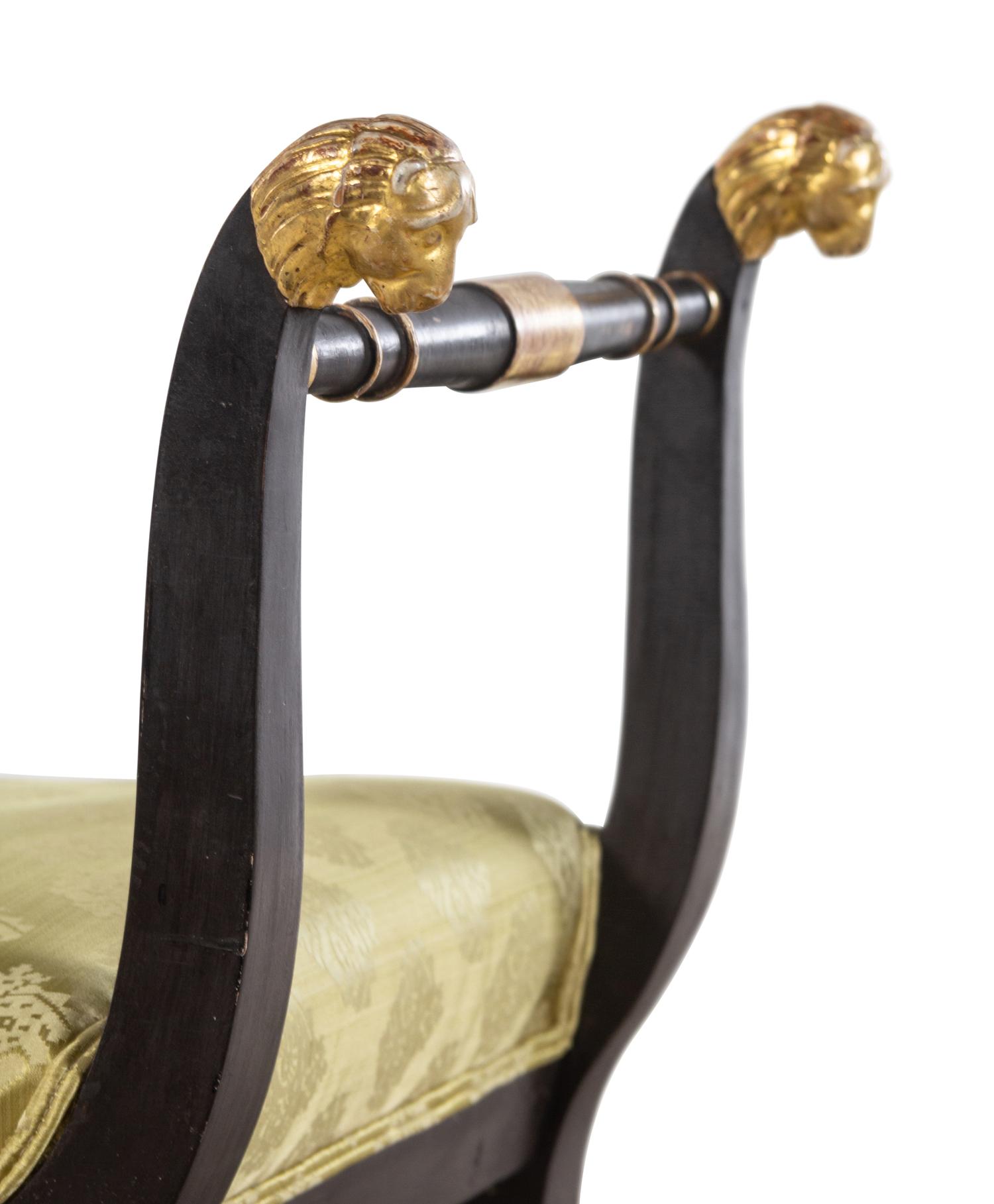 An Italian Parcel Gilt and Ebonized Curule Bench