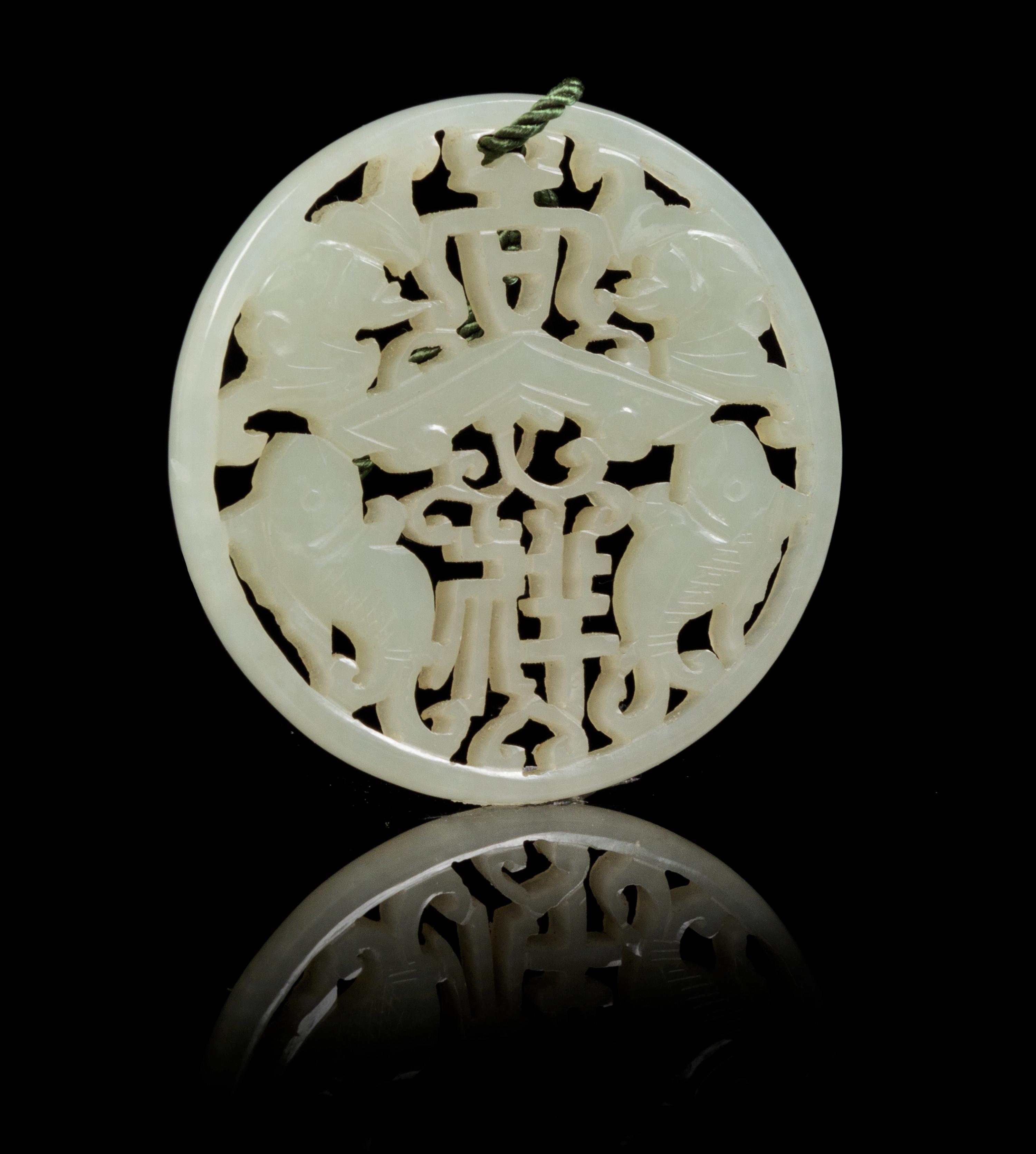 A Carved Celadon Jade Circular Pendant Diameter 2 1/4 inches.