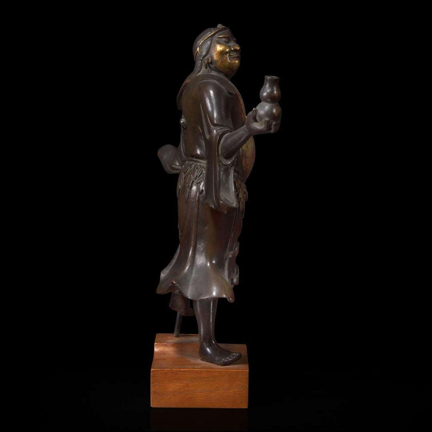 A finely modeled Chinese parcel-gilt and patinated bronze figure of Li Tieguai 部分漆金加画铁拐李铜造像 Late Ming/Early Qing dynasty ?????