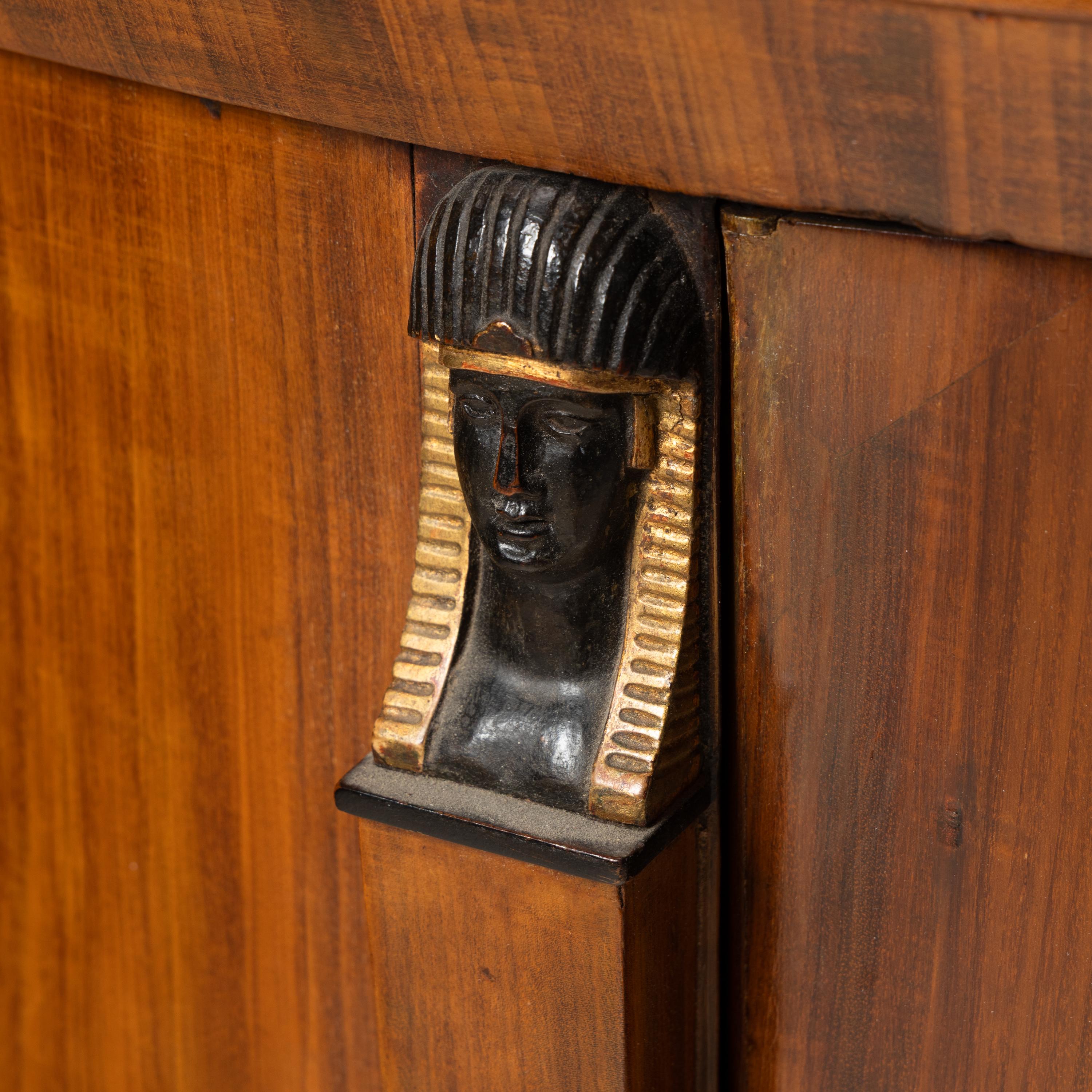 A German or Austrian Fruitwood, Part Ebonized and Parcel Gilt Marble Top Cabinet