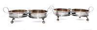 A Pair of George III Silver Two-Bottle Wine Trollies, Philip Bachelor, London, 1792, each with wood centers and raised on four feet wit