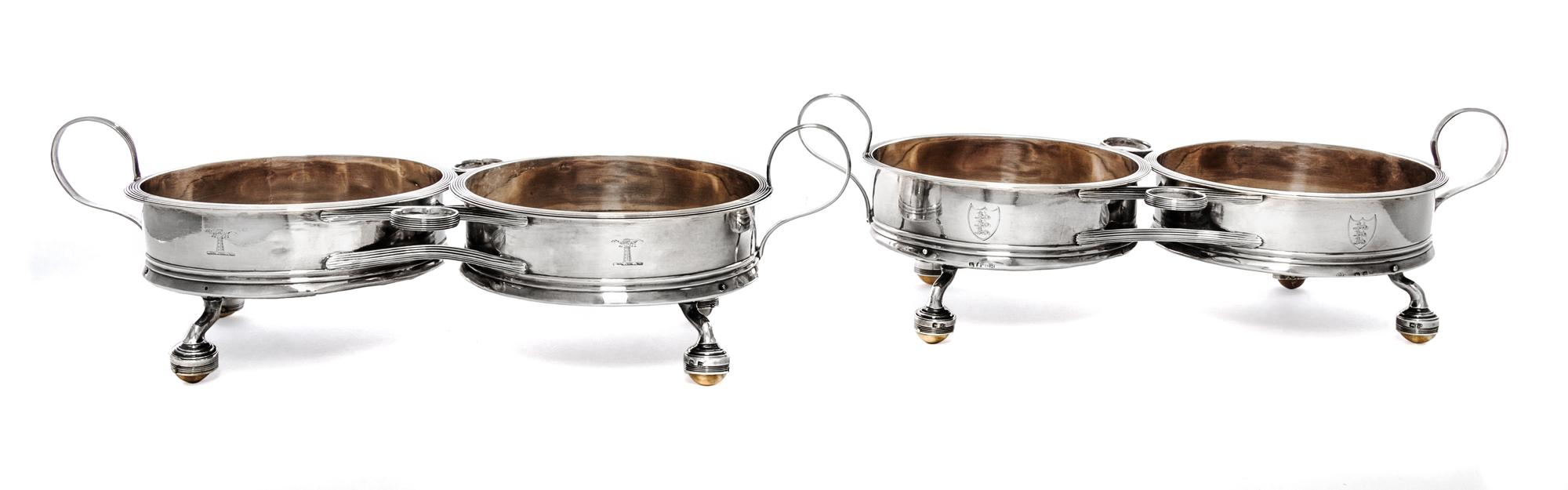 A Pair of George III Silver Two-Bottle Wine Trollies, Philip Bachelor, London, 1792, each with wood centers and raised on four feet wit