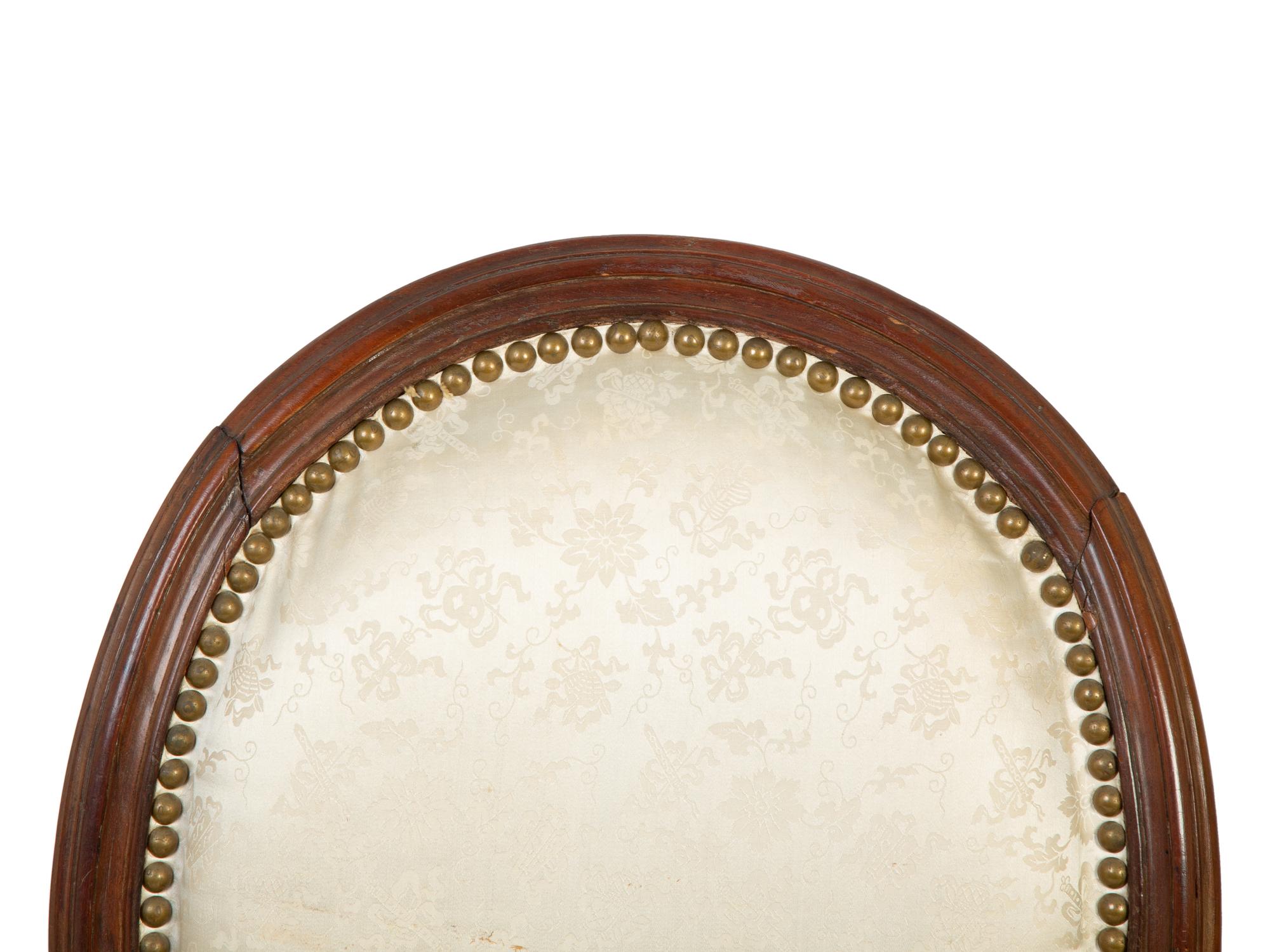 A Pair of Louis XVI Walnut Fauteuils en Cabriolet