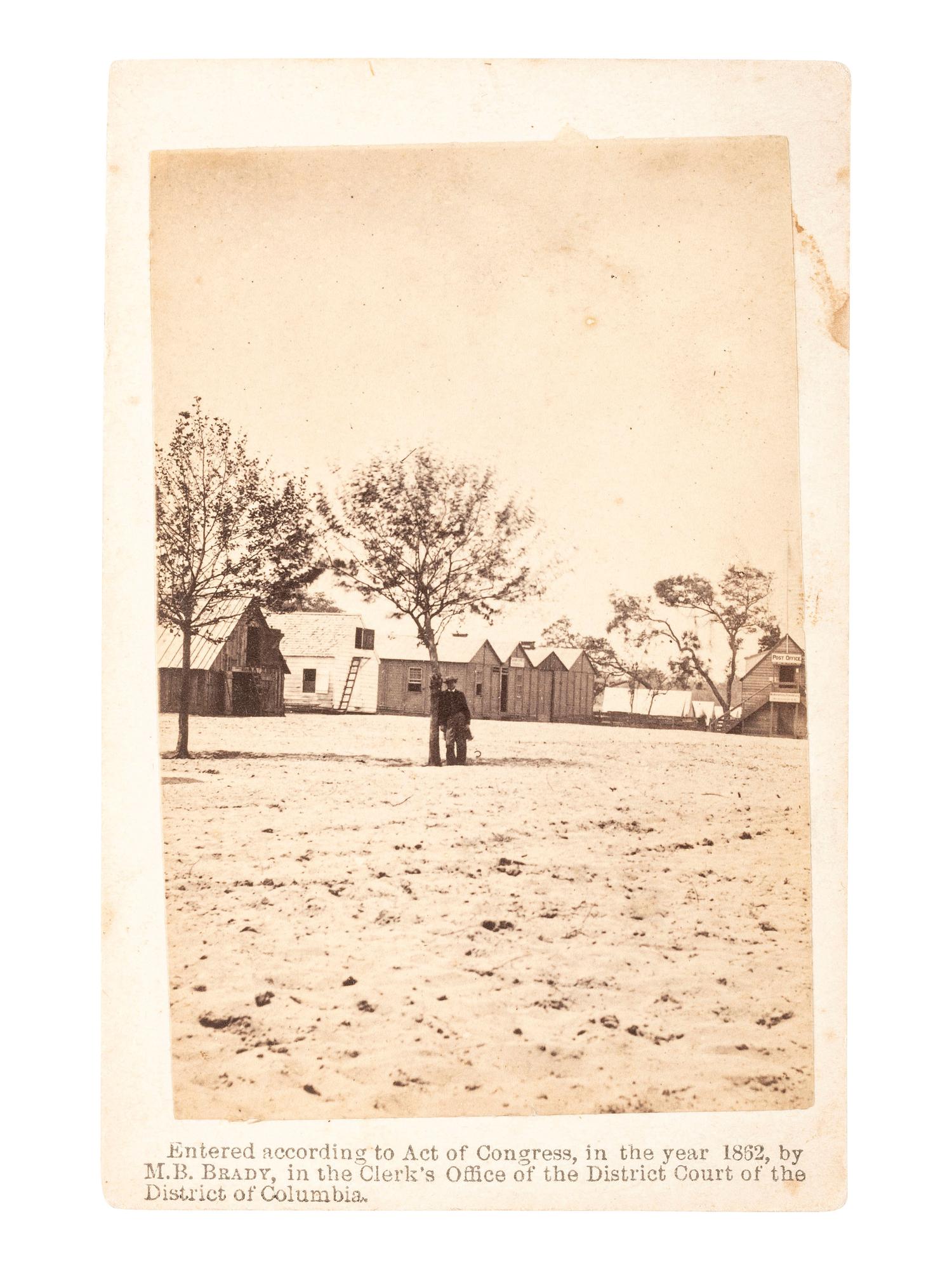 [CIVIL WAR]. BRADY, Mathew. CDV of man possibly wearing a frock coat at military barracks. Washington, D.C., 1862.