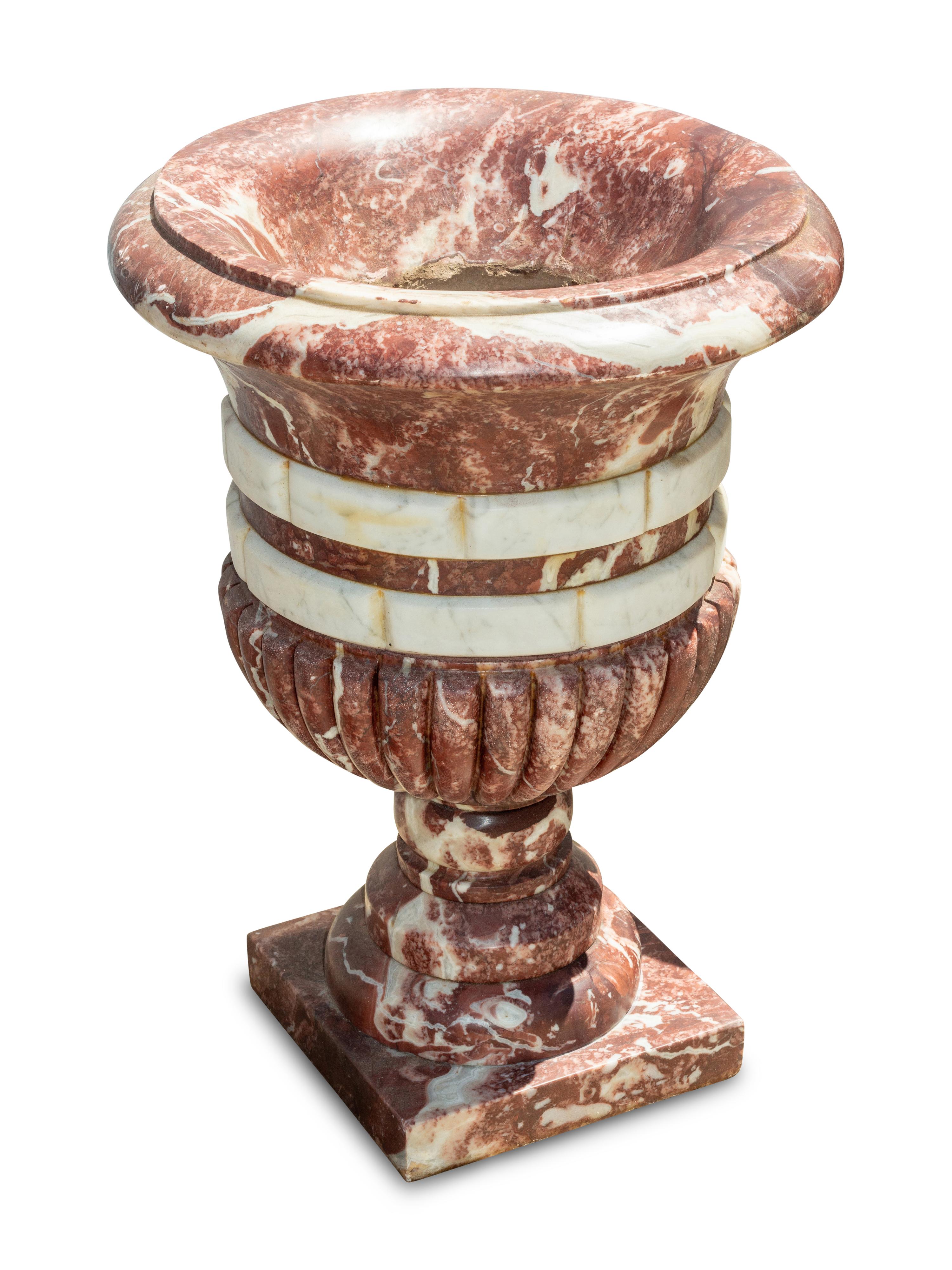 A Set of Four Italian Carved Red and White Marble Urns