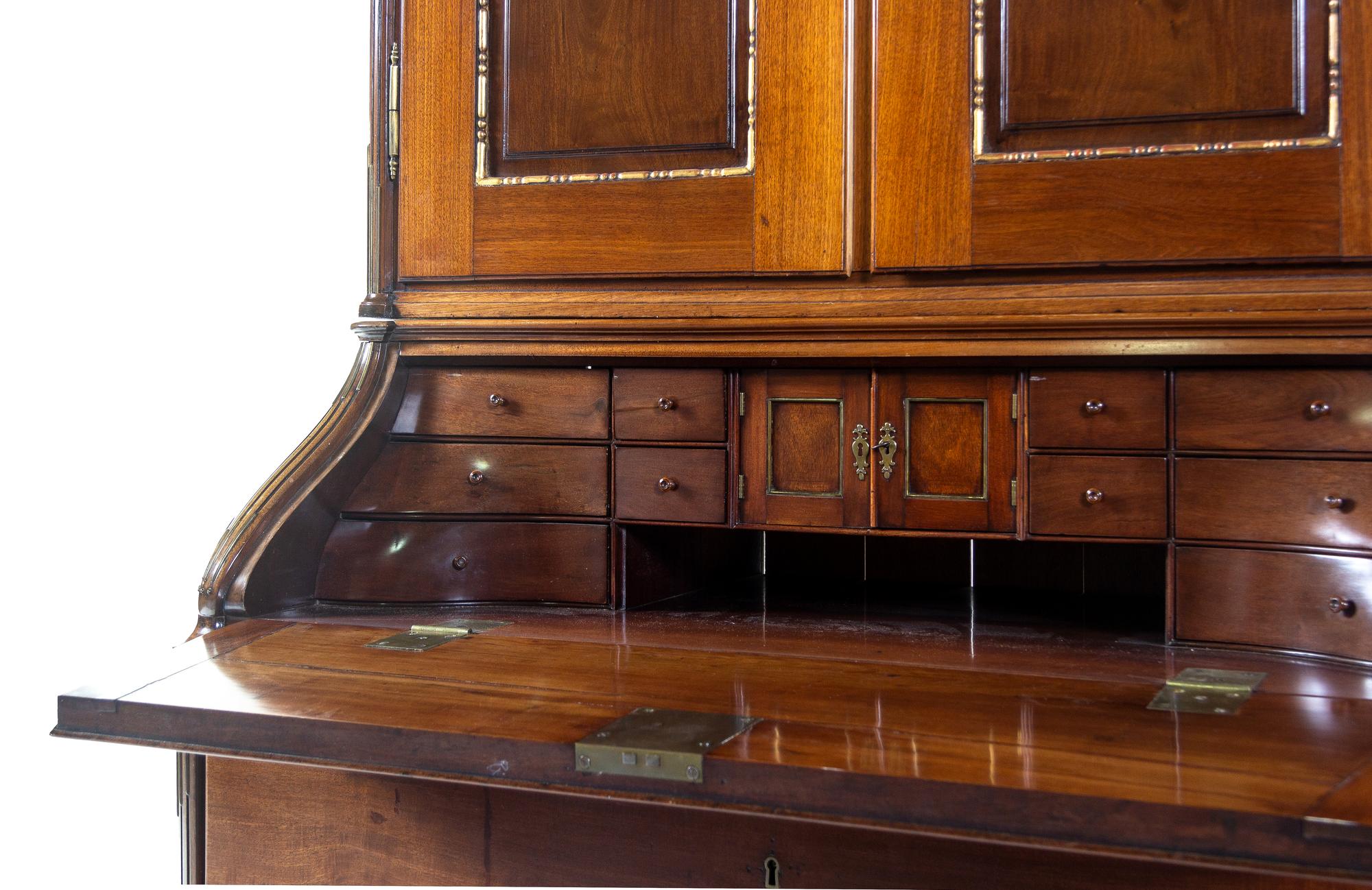 A Baltic Neoclassical Parcel Gilt Walnut Secretary