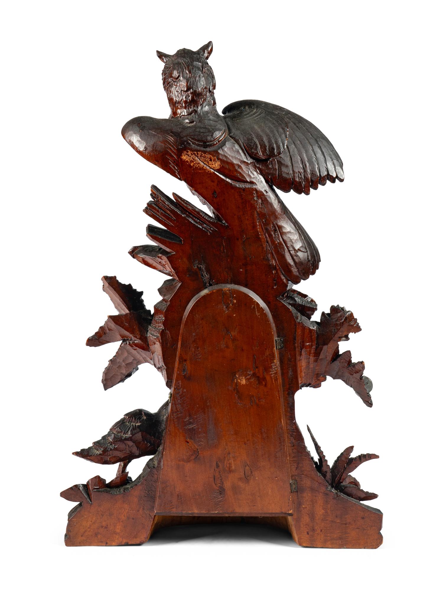 A Swiss "Black Forest" Carved Wood Clock