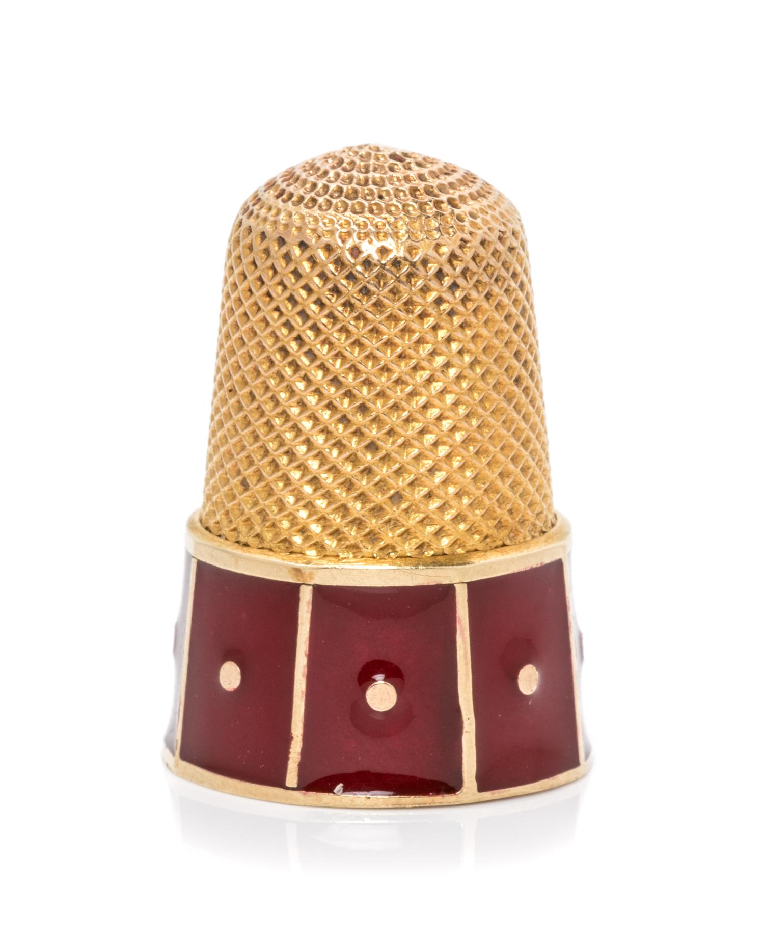 A Yellow Gold and Enamel Thimble, , the base decorated with red enamel panels.