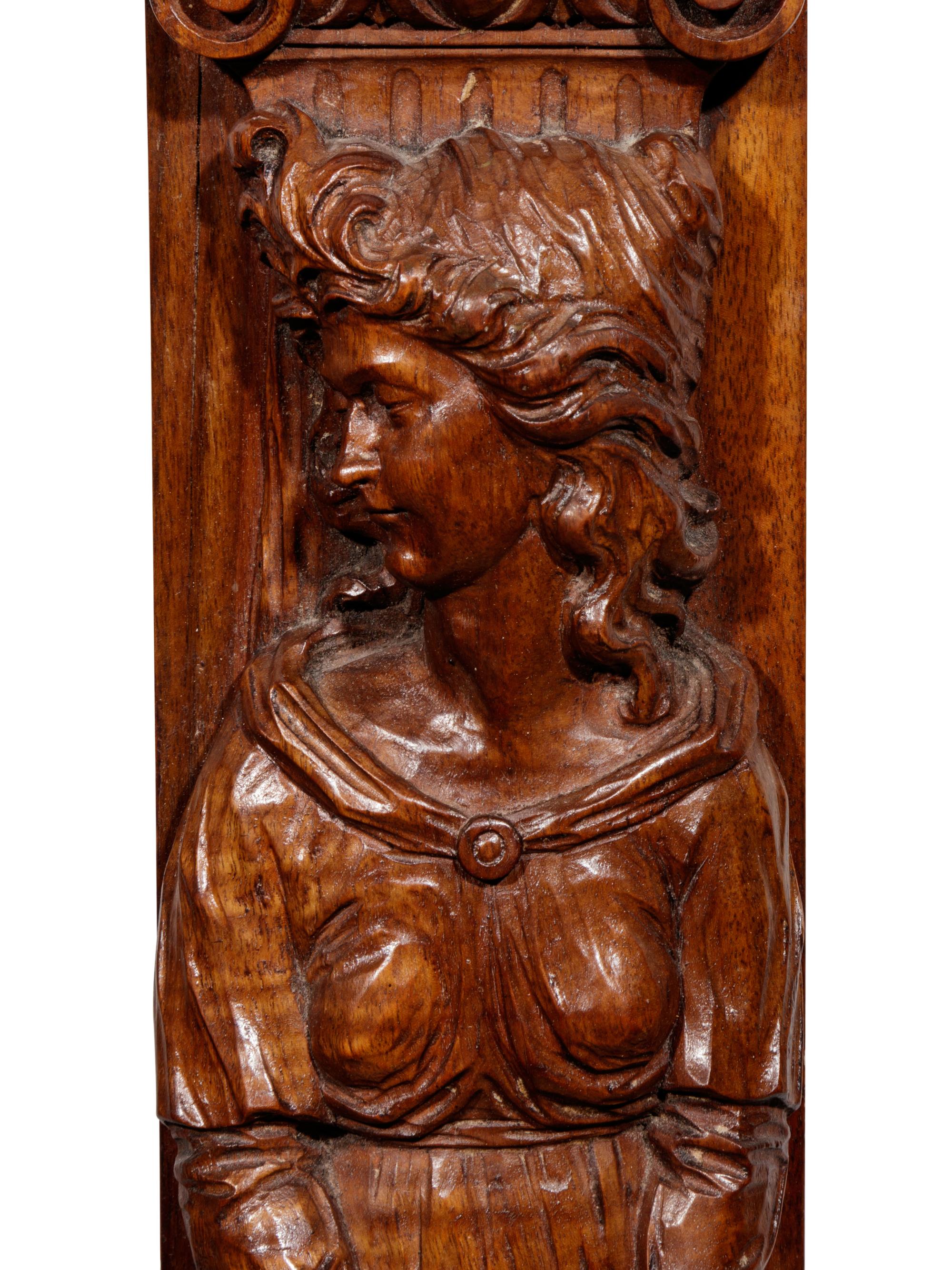 A Pair of Carved Oak Figural Pilasters