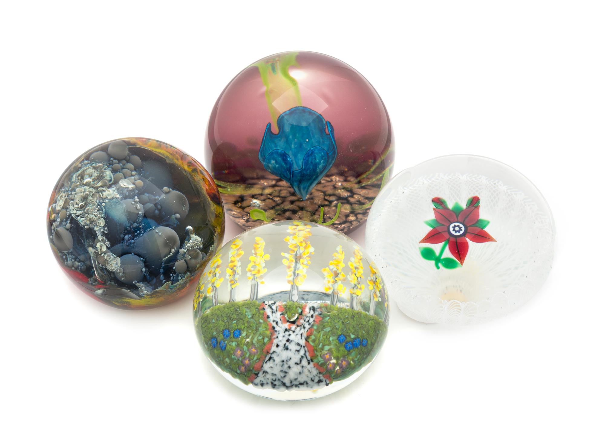 Four Glass Paperweights Diameter of largest 3 inches