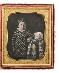 [EARLY PHOTOGRAPHY]. Sixth plate daguerreotype of a young boy standing beside a cat at rest.
