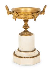 A French Gilt Bronze and Marble Mantel Clock with an Associated Pair of Urns