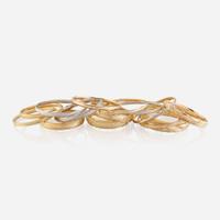 A collection of sixteen fourteen karat gold bangles