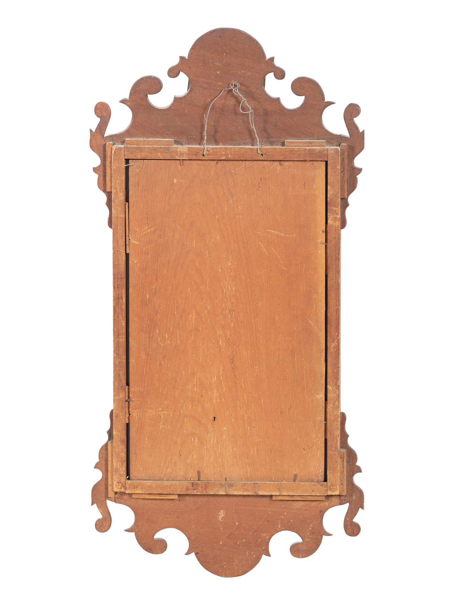 A Chippendale Carved and Parcel Gilt Mahogany Eagle-Decorated Looking Glass