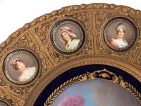 A Continental Porcelain Portrait and a Set of Twelve Similar Medallions in a Gilt Bronze Plaque