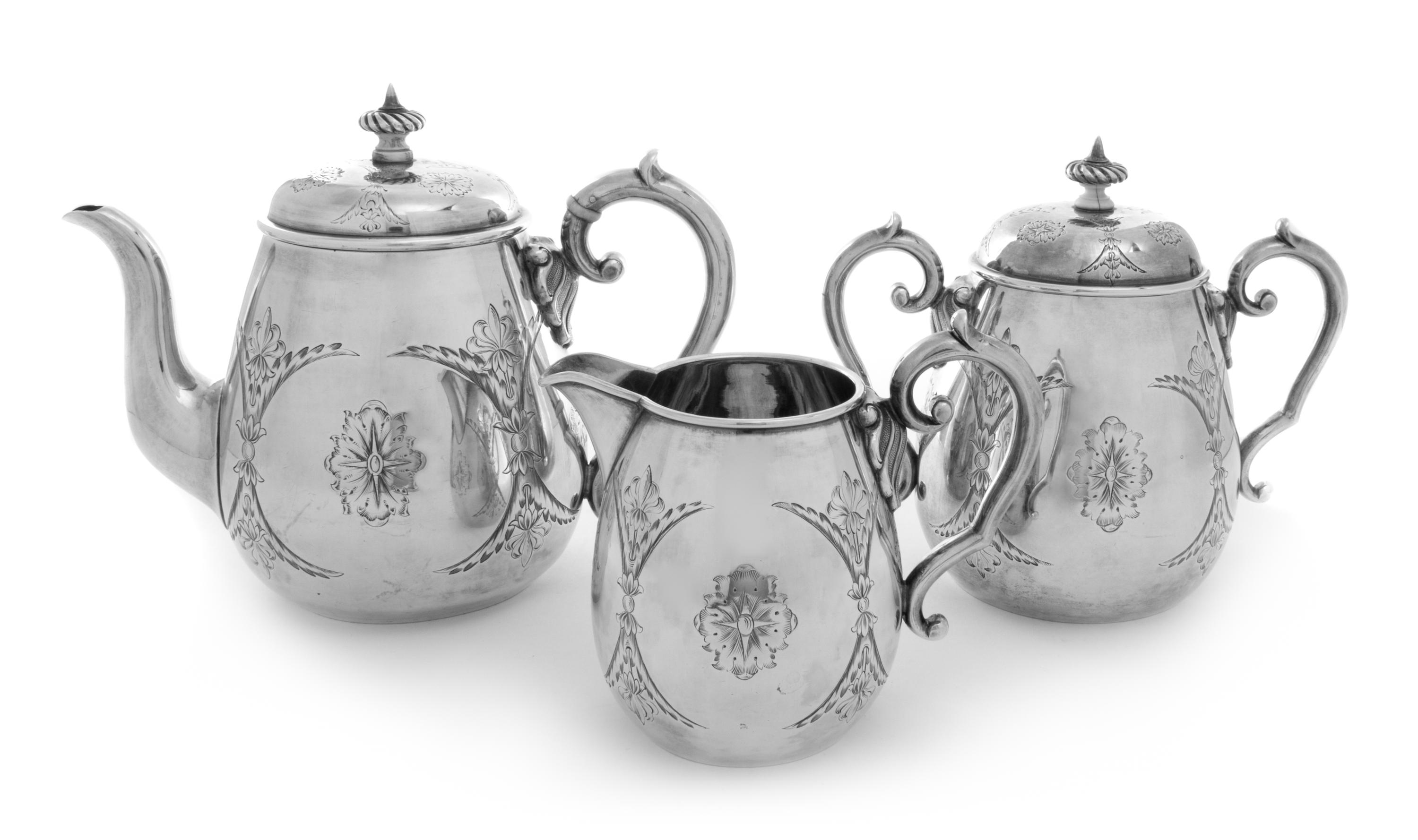 A Russian Silver Tea Service, Konstantine Petz, Moscow, 1863, comprising a teapot, a covered sugar and a creamer, each with bright cut