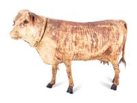 A Wood and Leather Mooing Cow-Form Pull Toy with Glass Eyes