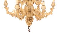 A Carved Fruitwood Ten Light Chandelier