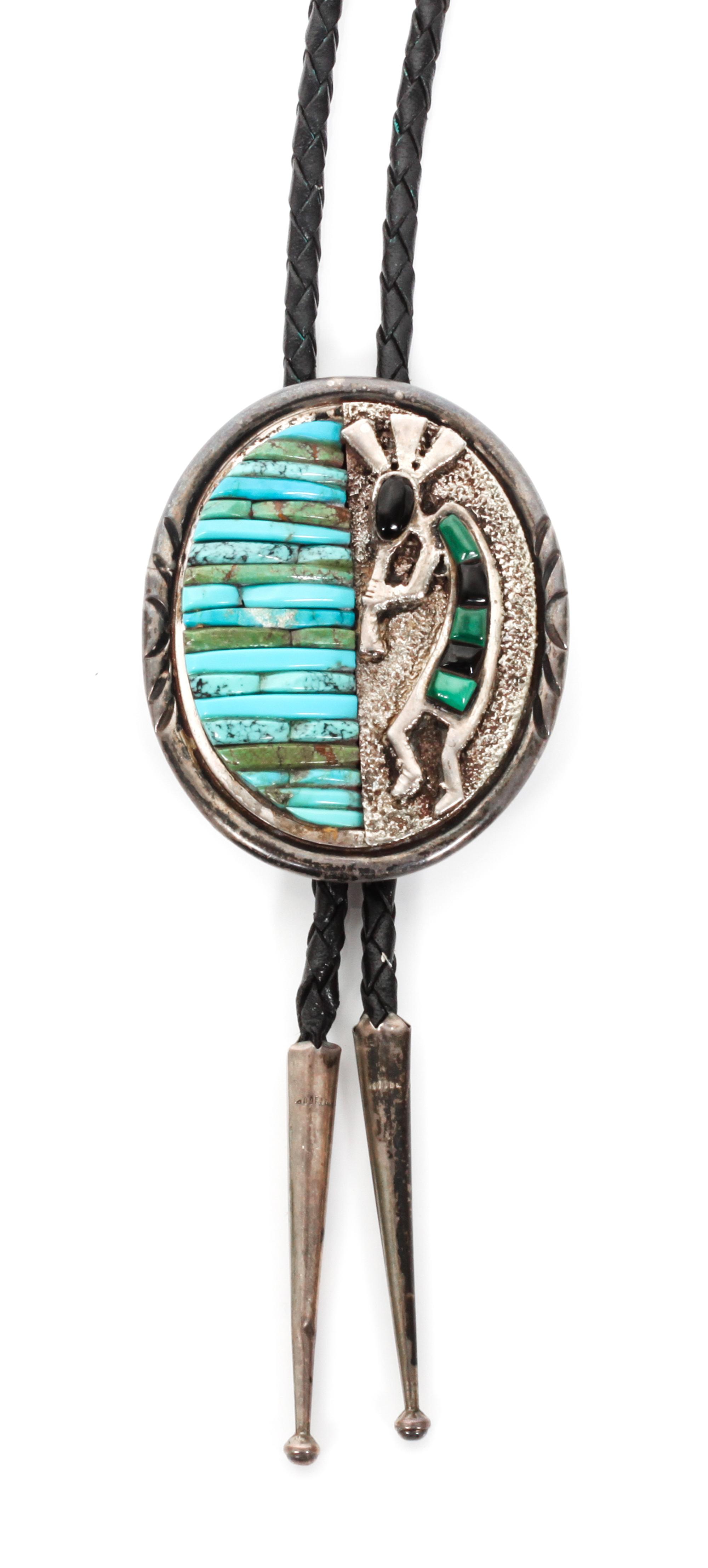 A Zuni and Navajo Silver, Turquoise and Multiple Stone Bolo, Charlene Dishta and Pete Sierra Height 2 1/2 x width 2 inches.