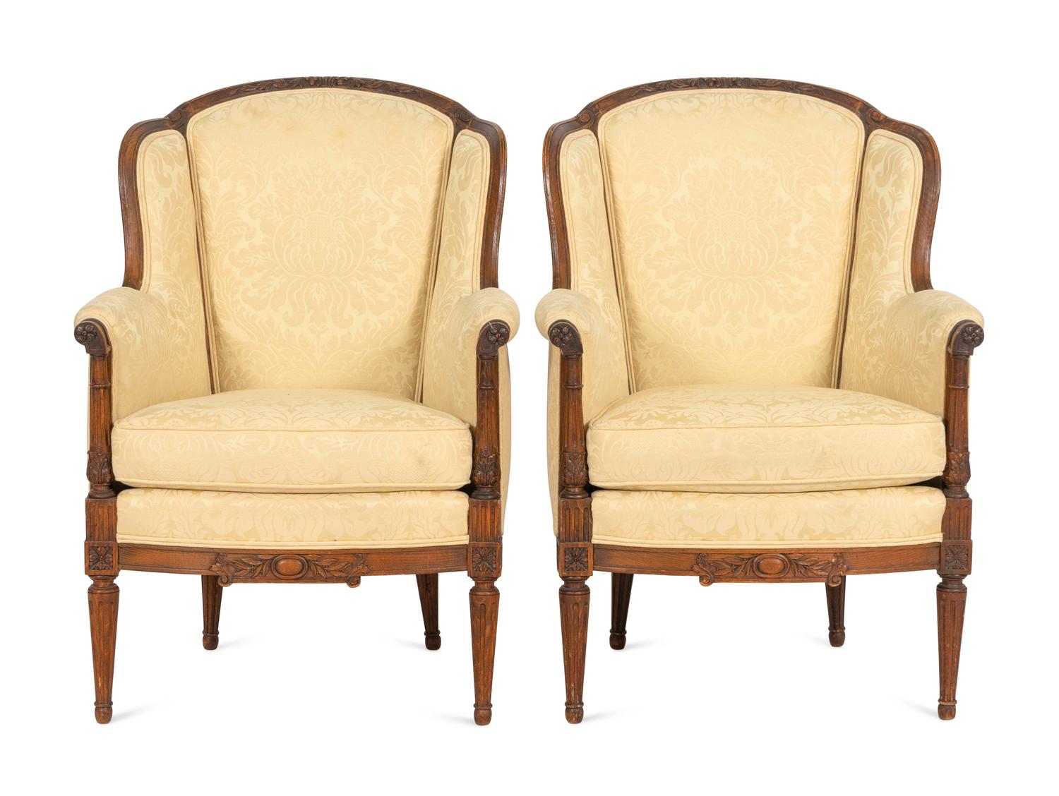 A Pair of Louis XVI Style Carved Walnut Bergères