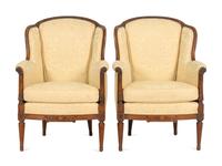 A Pair of Louis XVI Style Carved Walnut Bergères