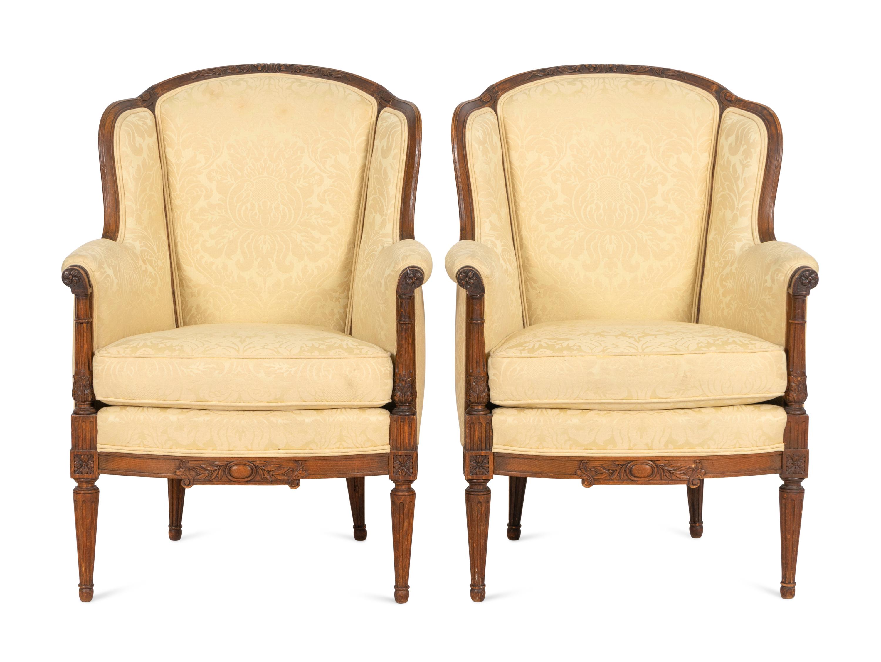 A Pair of Louis XVI Style Carved Walnut Bergères