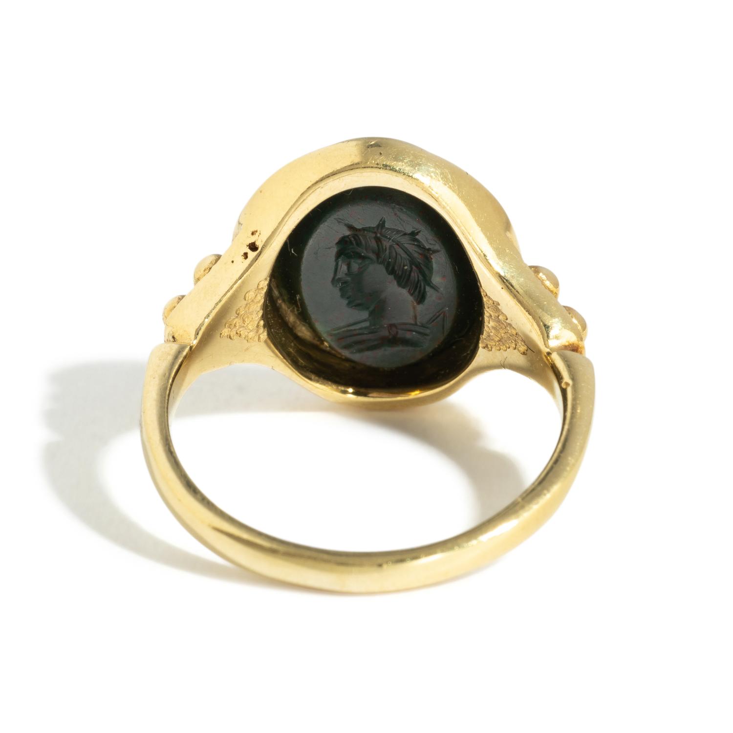 A Roman Bloodstone Double-Sided Ring Stone with the Gods Venus and Eros & a Portrait Head of a Deity — Set in a gold ring, '18k' stamped on inside
