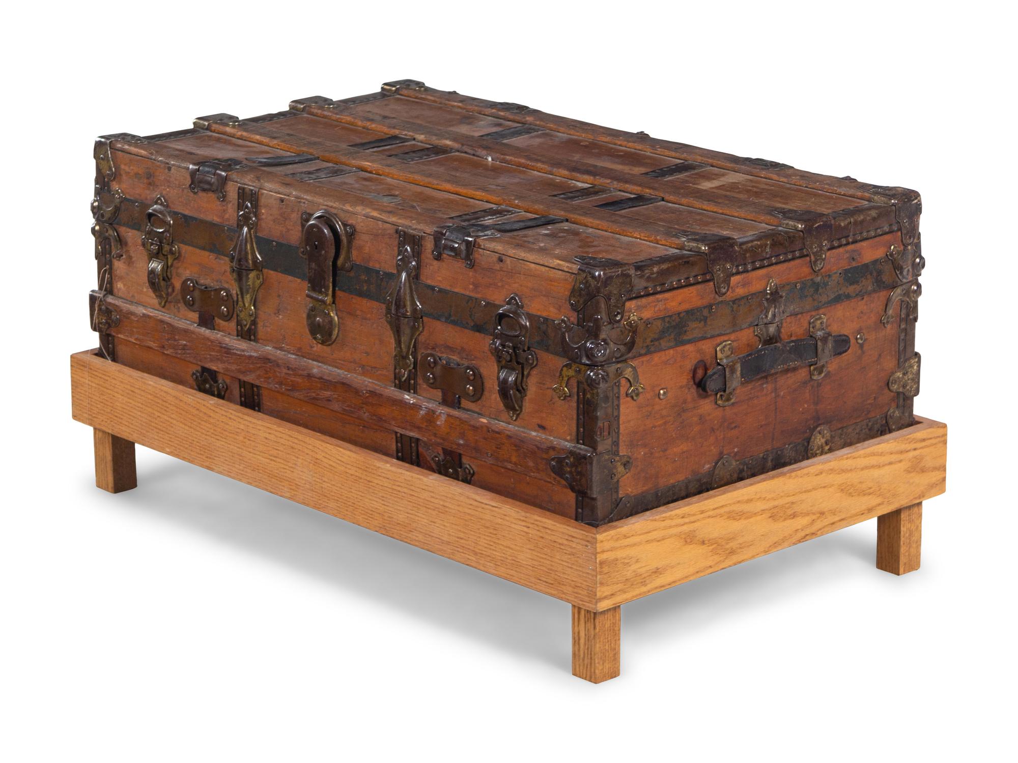 A Goldsmith & Son Never Break Trunk Raised on a Later Stand as a Table