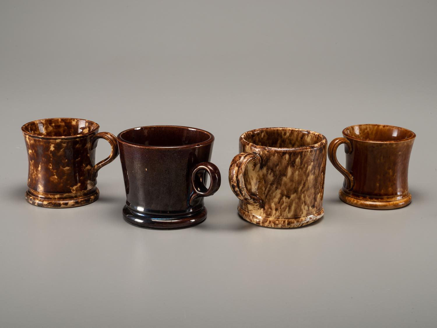 Fifteen Rockingham Glaze Mugs and Pig Banks