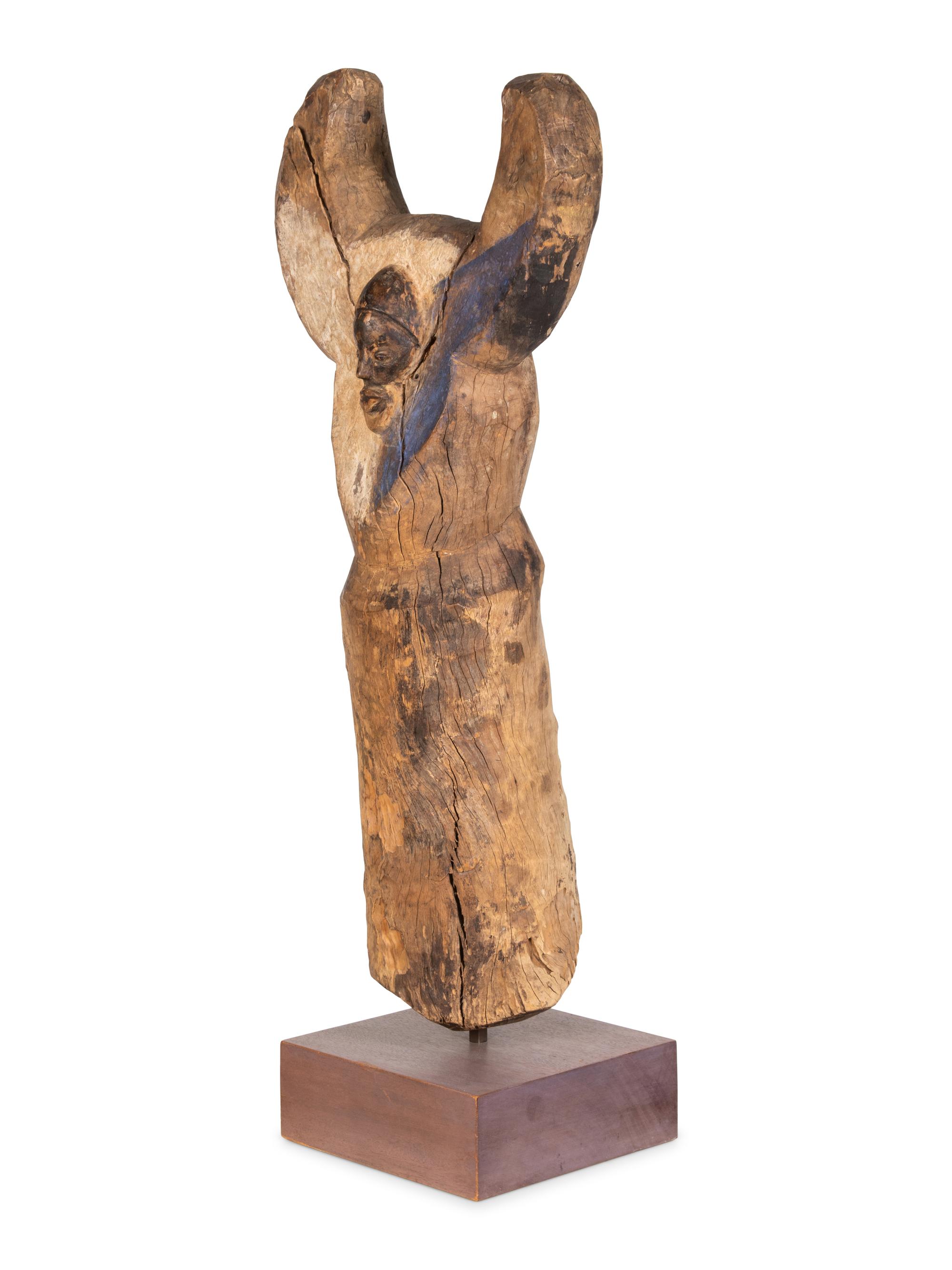 A Yaka Post, with forked finial painted blue and white, a mask in relief at the center