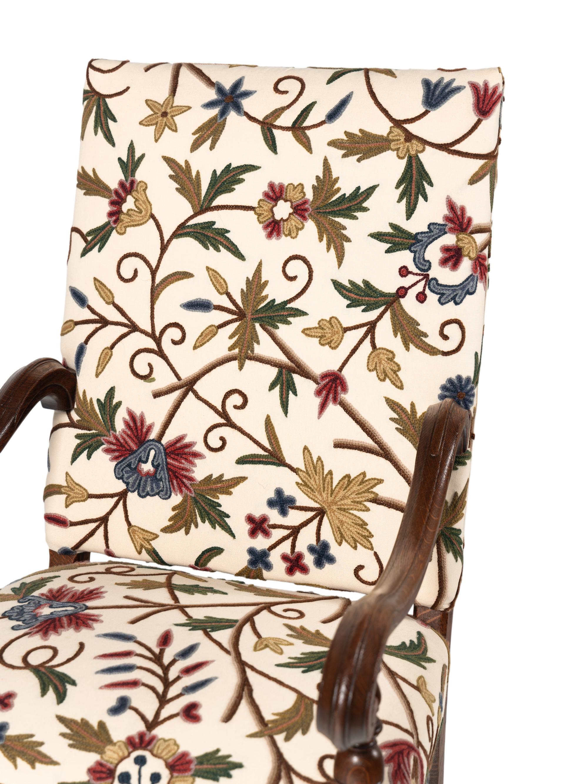 A Pair of William and Mary Style Walnut Armchairs with Crewelwork Upholstery