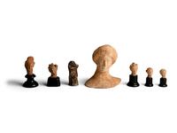 Six Greek Terracotta Heads and One Headless Figure