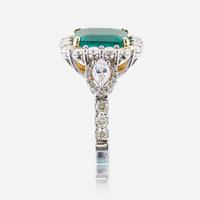 An emerald, diamond, and eighteen karat white gold ring