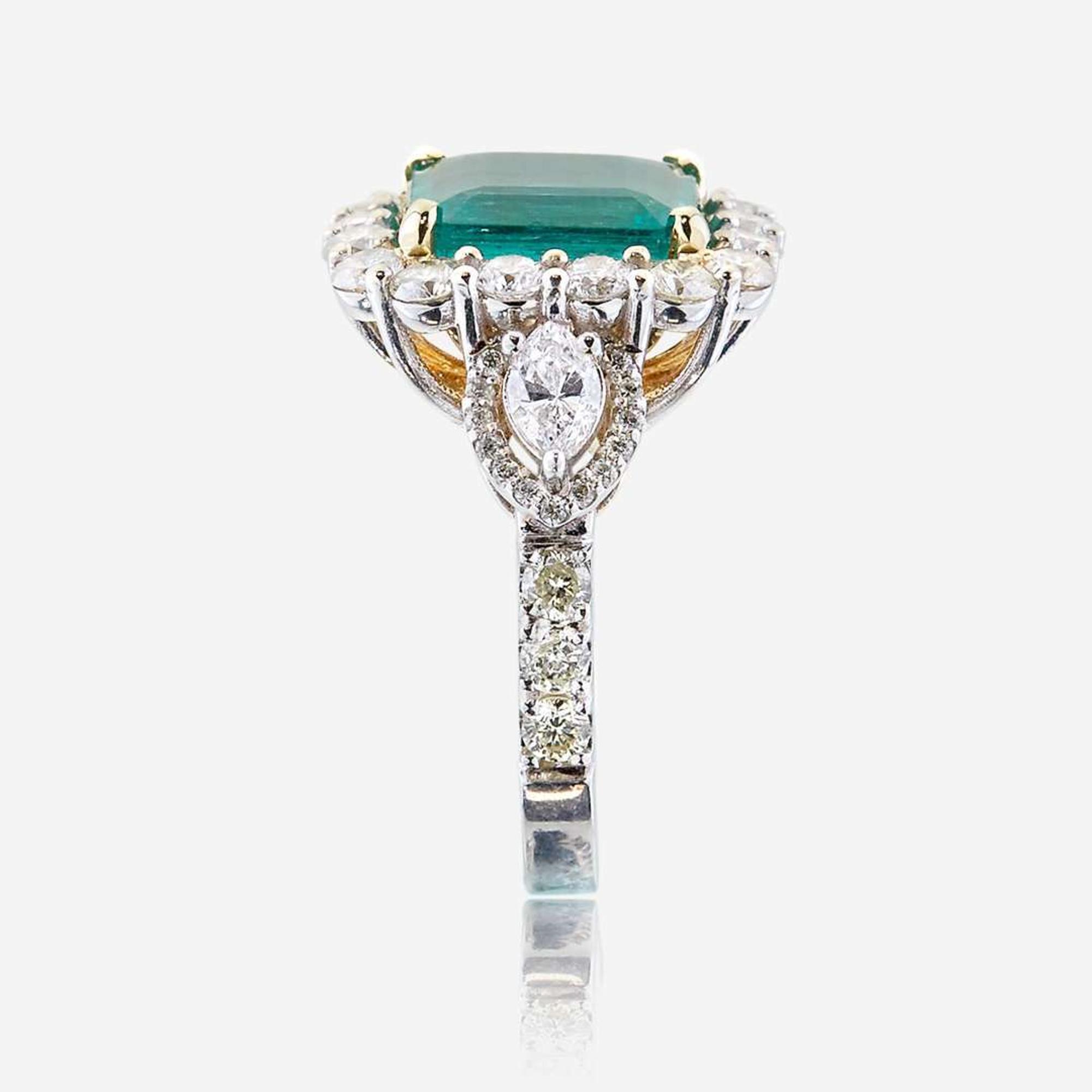 An emerald, diamond, and eighteen karat white gold ring