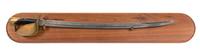 A Brass and Wooden Handle Cutlass Sword on a Mahogany Backboard Length 24 inches.